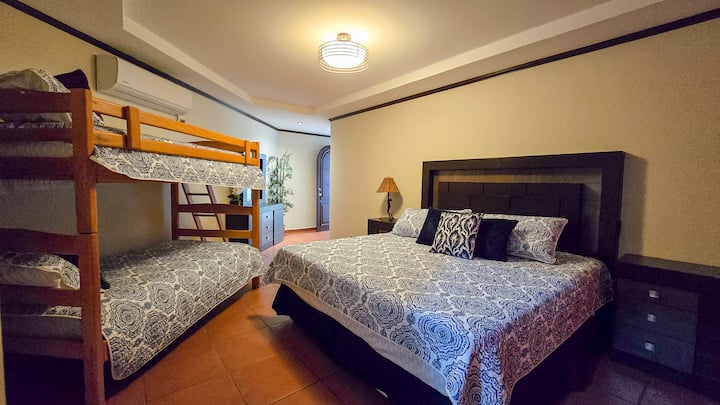 Dormitorio con cama y litera en Costa del Sol
